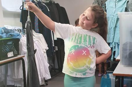 girl choosing school uniform